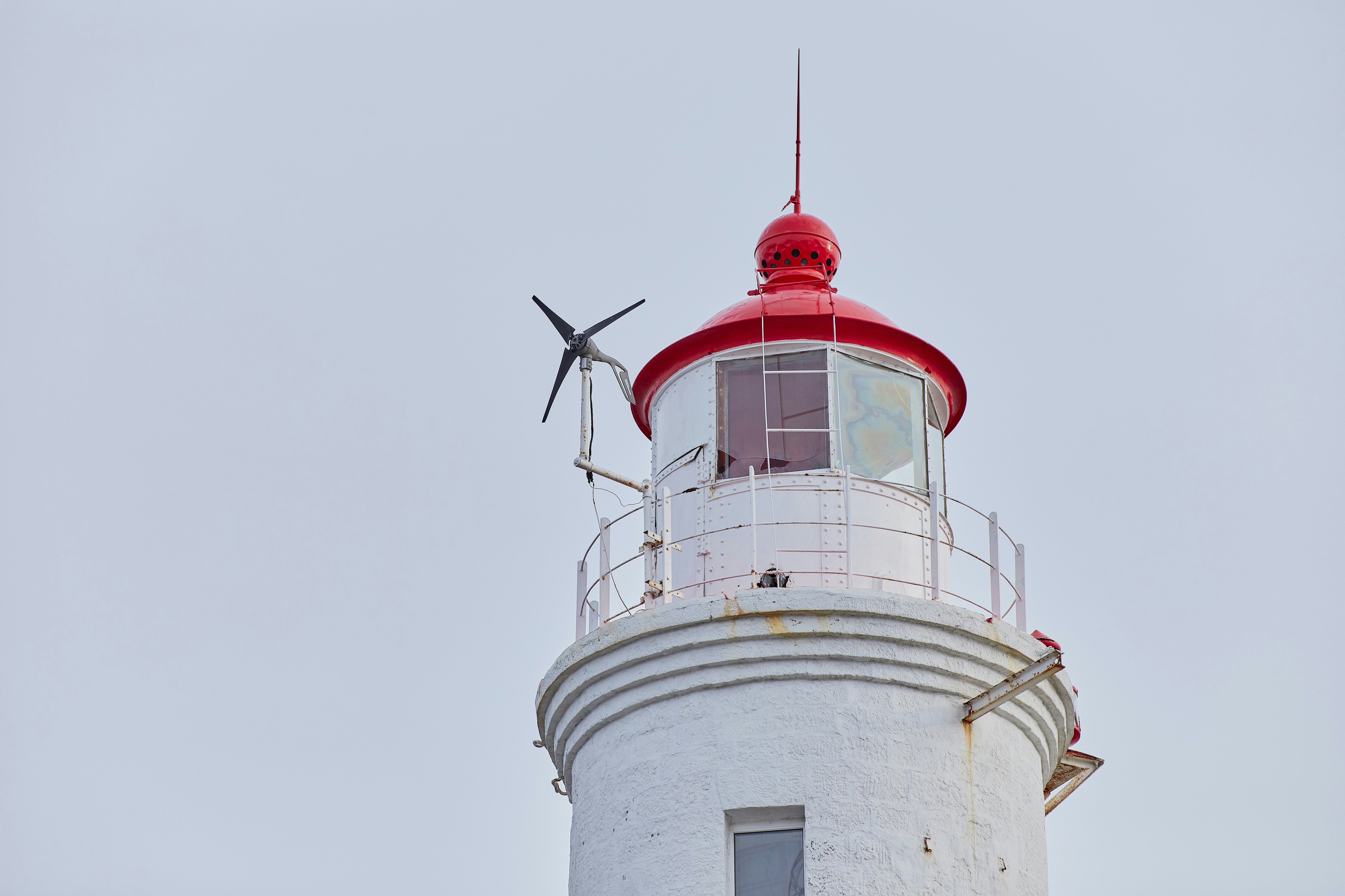 white and red concrete lighthouse